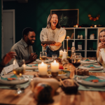 A joyful group of friends gathered around a candlelit dinner table, laughing and sharing a cozy low-sugar winter meal together in a warm, festive home setting.