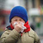 Child showing cold symptoms in winter, illustrating weakened immunity at the cellular level.