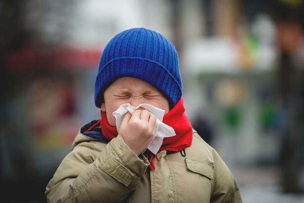 Child showing cold symptoms in winter, illustrating weakened immunity at the cellular level.