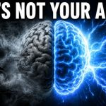 Split-screen image of a human brain against a dark background. The left half is dull gray and surrounded by thick swirling fog, smoke, and static-like distortion, symbolizing brain fog and mental fatigue. The right half glows bright blue and white with sharp details and lightning-like energy radiating outward, representing mental clarity and focus. Large bold white text across the top reads, "IT'S NOT YOUR AGE." The image uses dramatic lighting, high contrast, and a photorealistic 3D render style designed for a YouTube thumbnail.