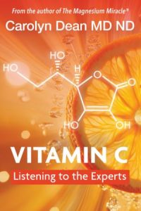Vitamin_C_Listening_to_the_Experts_cover Book cover with a vibrant orange and gold background featuring a close-up slice of an orange radiating light. A white chemical structure representing vitamin C (ascorbic acid) overlays the center of the image. At the top, white text reads, "From the author of The Magnesium Miracle®," followed by "Carolyn Dean MD ND." Large white text near the bottom reads "VITAMIN C," with a red banner underneath that says "Listening to the Experts." The overall design emphasizes brightness, vitality, and citrus imagery associated with vitamin