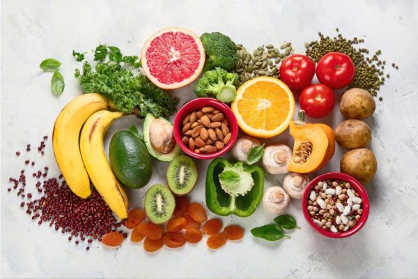 Mineral-rich foods including leafy greens, avocado, almonds, beans, bananas, citrus fruits, and vegetables that support cellular health, energy, and nutrition.